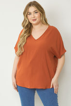 Load image into Gallery viewer, Plus size Solid v-neck top featuring asymmetric rounded hem detail
