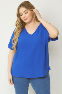 Plus size Solid v-neck top featuring asymmetric rounded hem detail