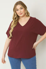 Load image into Gallery viewer, Plus size Solid v-neck top featuring asymmetric rounded hem detail
