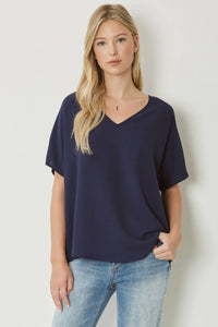Plus size Solid v-neck top featuring asymmetric rounded hem detail