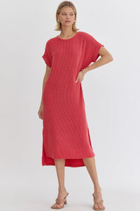 Ribbed short sleeve midi dress featuring slit at side hem. Unlined. Knit. Non-sheer. Lightweight.